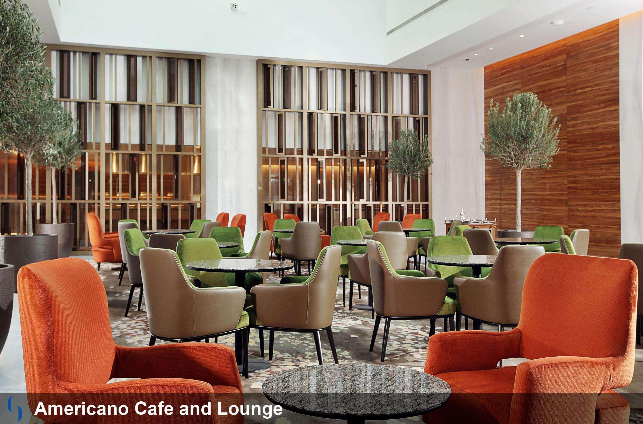 โรงแรมแกรนด์ คอสโมโพลิตัน - ดูไบ ภายนอก รูปภาพ The image shows a modern café and lounge area called "Americano Café and Lounge." The interior features a spacious, well-lit design with a mix of stylish furniture. There are several seating areas with comfortable chairs in various colors, including 